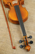 Violin and bow on jute sack background