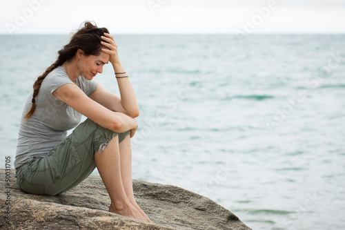 Photo: Upset crying woman by the ocean Upset crying woman by the ocean