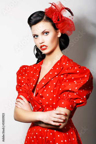 Photo: Strict Lady in Red Retro Dress - crossed hands. Proud Brunette Strict Lady in Red Retro Dress - crossed hands. Proud Brunette