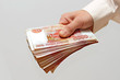 a bundle of money in the hand of a man
