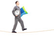 Full length portrait of a young man with pillow and clock sleepw