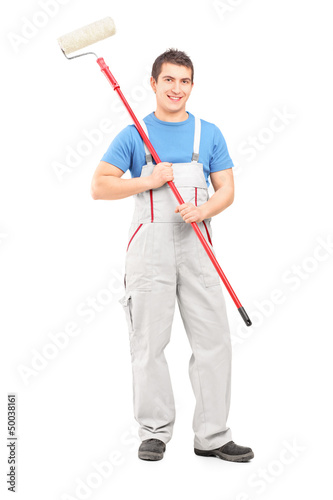 Photo: Full length portrait of a confident painter in a uniform with a Full length portrait of a confident painter in a uniform with a