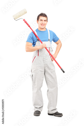 Photo: Full length portrait of a smiling painter in a uniform with a br Full length portrait of a smiling painter in a uniform with a br