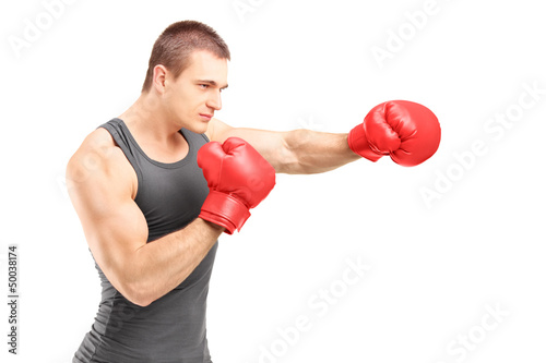 Photo: Male boxer punching with red boxing gloves Male boxer punching with red boxing gloves