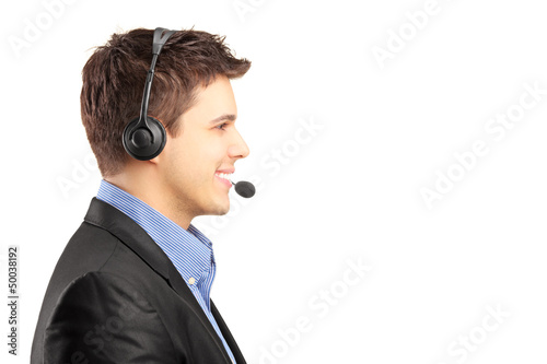 Photo: Smiling customer service employee in profile with headset on Smiling customer service employee in profile with headset on