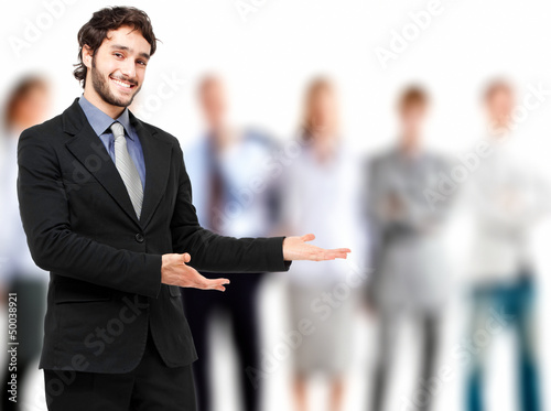 Photo: Young businessman presenting his team Young businessman presenting his team