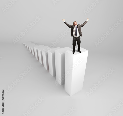 Photo: happy businnesman standing on column happy businnesman standing on column