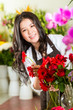 Photo: Chinese Saleswoman in a flower shop Chinese Saleswoman in a flower shop