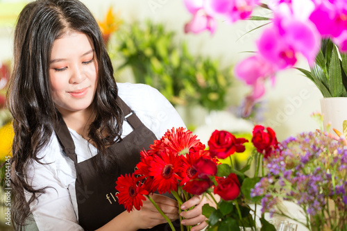 Photo: Chinese Saleswoman in a flower shop Chinese Saleswoman in a flower shop