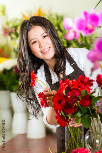 Photo: Chinese Saleswoman in a flower shop Chinese Saleswoman in a flower shop