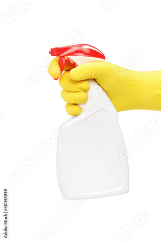 Photo: Studio shot of a hand with rubber glove holding a cleaning spray Studio shot of a hand with rubber glove holding a cleaning spray