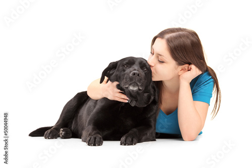 Photo: Young female hugging and kissing her dog Young female hugging and kissing her dog