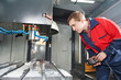 worker operating CNC machine center