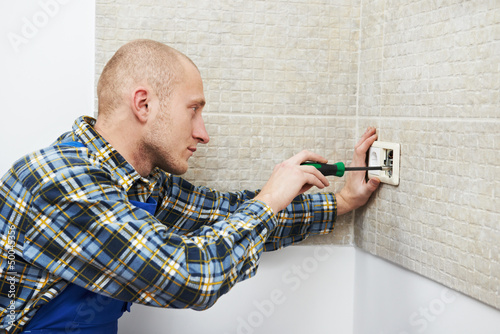 Photo: Electrician installing wall outlets Electrician installing wall outlets