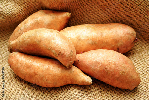 Photo: Close-Up of 5 Sweet Potatoes on Burlap Close-Up of 5 Sweet Potatoes on Burlap