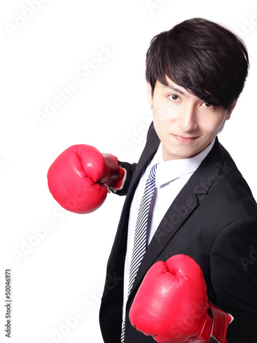 Photo: Asian businessman battle with boxing glove Asian businessman battle with boxing glove