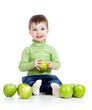 happy baby boy with green apples isolated on white background