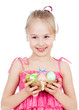 Foto: cute smiling kid girl holding Easter eggs in basket cute smiling kid girl holding Easter eggs in basket