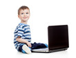 baby boy using a laptop over white background