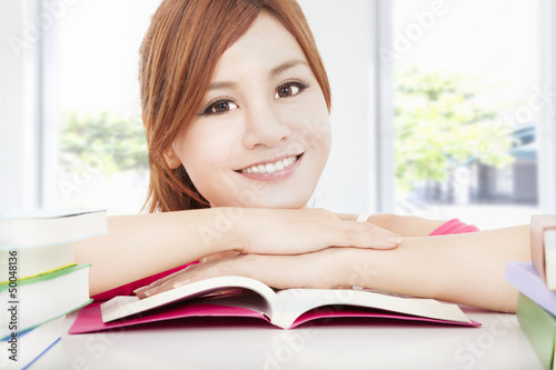 Photo: happy student asian girl reading book happy student asian girl reading book