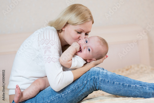 Photo: mother playing with baby boy indoors mother playing with baby boy indoors
