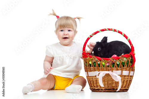 Photo: funny baby girl with Easter bunny in basket funny baby girl with Easter bunny in basket