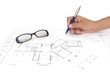 hand with Architect’s plans.