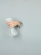 female hand holding liquid detergent container