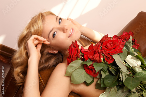Photo: Young beautiful blonde woman with flowers Young beautiful blonde woman with flowers