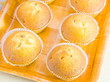cakes in paper forms on a decorative tray
