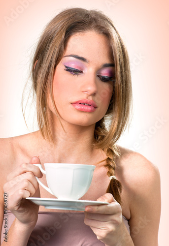 Photo: Beautiful young woman with a cup of tea/coffee Beautiful young woman with a cup of tea/coffee