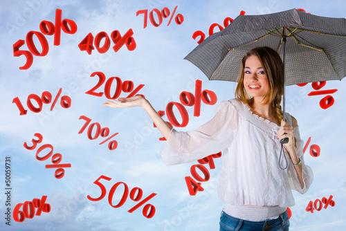 Photo: Girl over a sky background, percents falling Girl over a sky background, percents falling
