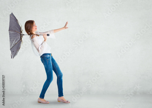 Photo: Girl over a white wall, wind blowing Girl over a white wall, wind blowing