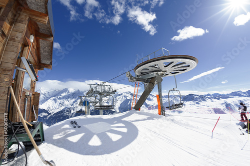 Photo: Ski chair-lift arrival in alpine mountain Ski chair-lift arrival in alpine mountain