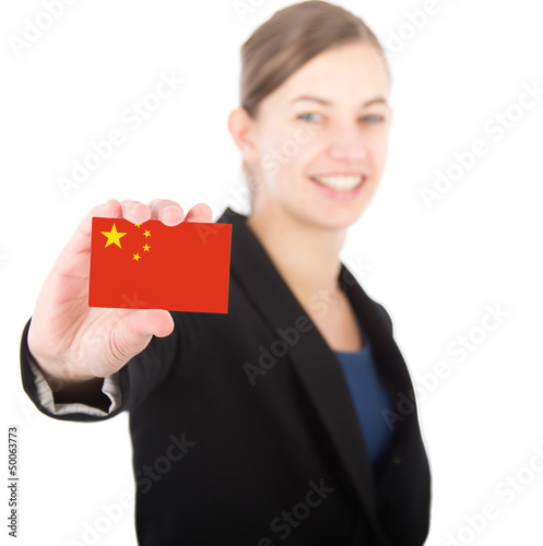 Photo: business woman holding a card with the Chinese flag business woman holding a card with the Chinese flag
