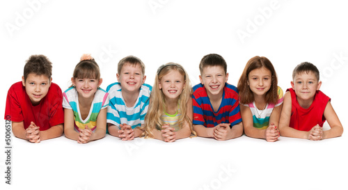 Photo: Seven children lying on floor Seven children lying on floor