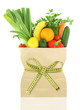 Fresh vegetables and fruits in a paper grocery bag 