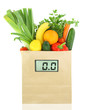 Fresh vegetables and fruits in a paper grocery bag