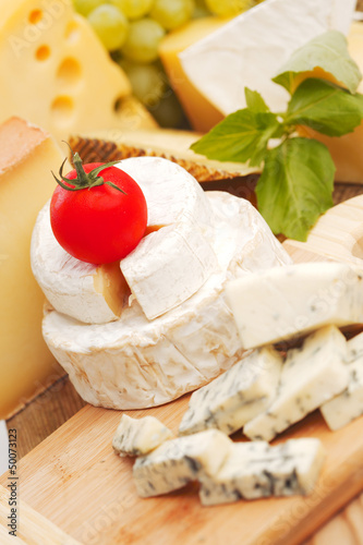 Photo: cheese on a wooden table cheese on a wooden table