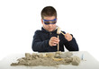 Child archaeologist excavating for dinosaur fossil