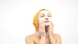 woman doing cosmetic mask on her face