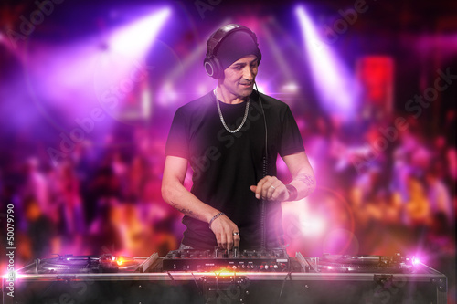 Photo: DJ is working at the disco DJ is working at the disco