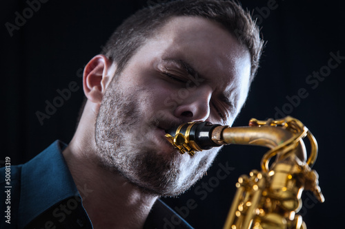 Photo: Young man playing the Saxophone. Young man playing the Saxophone.