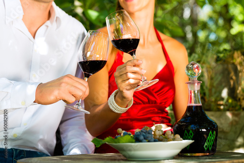 Photo: Woman and man in vineyard drinking wine Woman and man in vineyard drinking wine