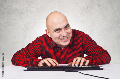 Photo: man with computer keybaord man with computer keybaord