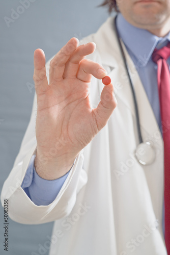 Photo: Doctor holding pill Doctor holding pill