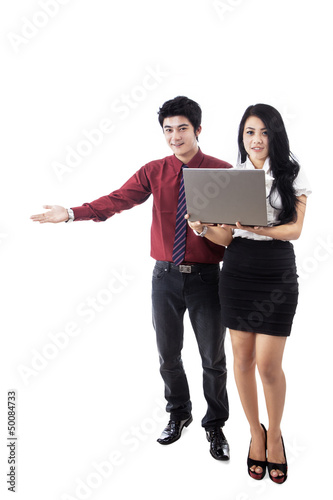 Photo: Attractive couple giving presentation Attractive couple giving presentation