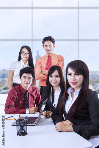 Photo: Confident business team in office Confident business team in office