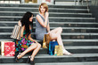 Two young women with shopping bags