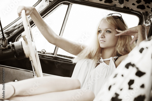 Photo: Young woman in a retro car Young woman in a retro car